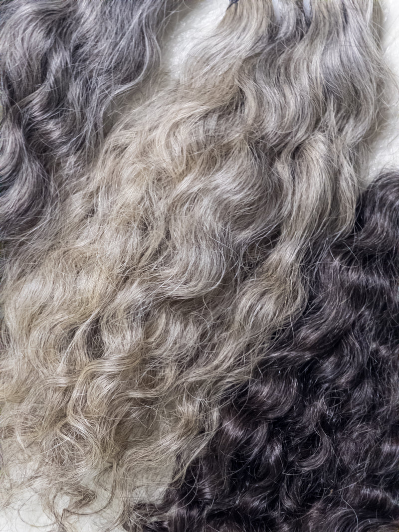 Opulent gray curly hair bundles showcasing luxurious waves in various shades for stylish hairstyles