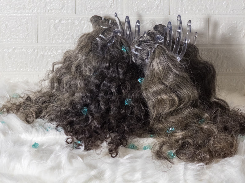 Opulent gray curly hair bundles displayed with clips on a soft white background