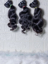 Opulent Raw Indian wavy bundles displayed in three sections with soft waves and natural shine
