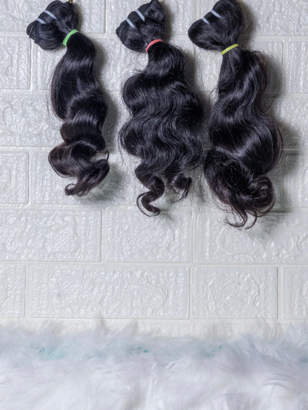 Opulent Raw Indian wavy bundles displayed in three sections with soft waves and natural shine