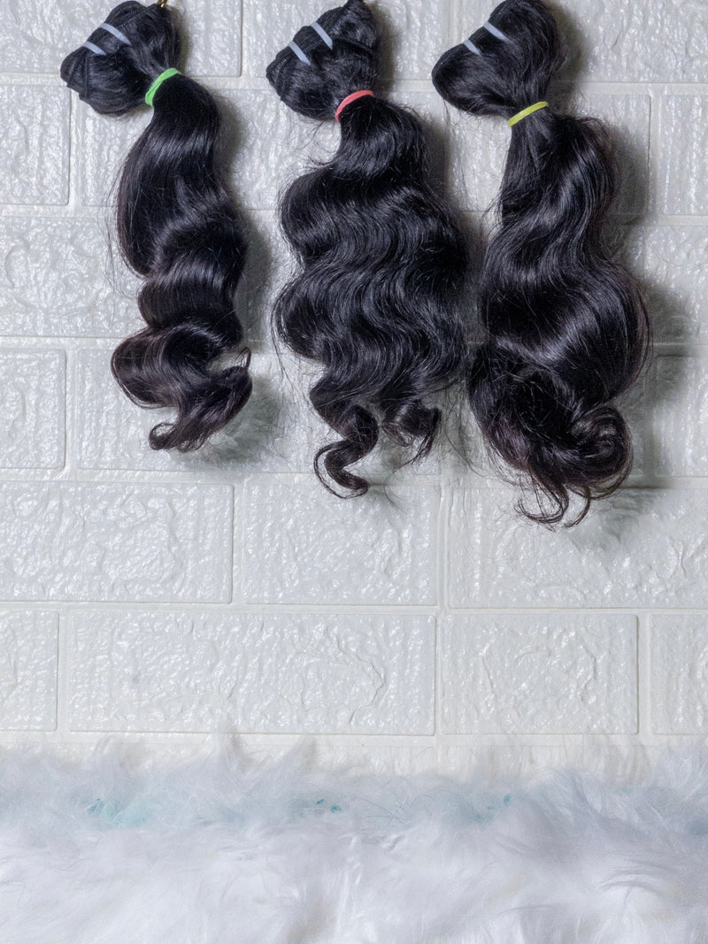 Opulent Raw Indian wavy bundles displayed in three sections with soft waves and natural shine