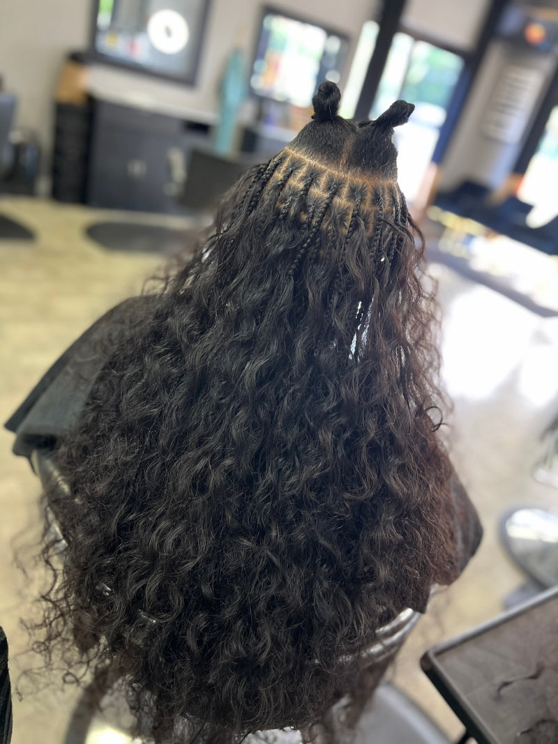 Back view of a hairstyle with raw Indian curly hair bundles styled on a mannequin