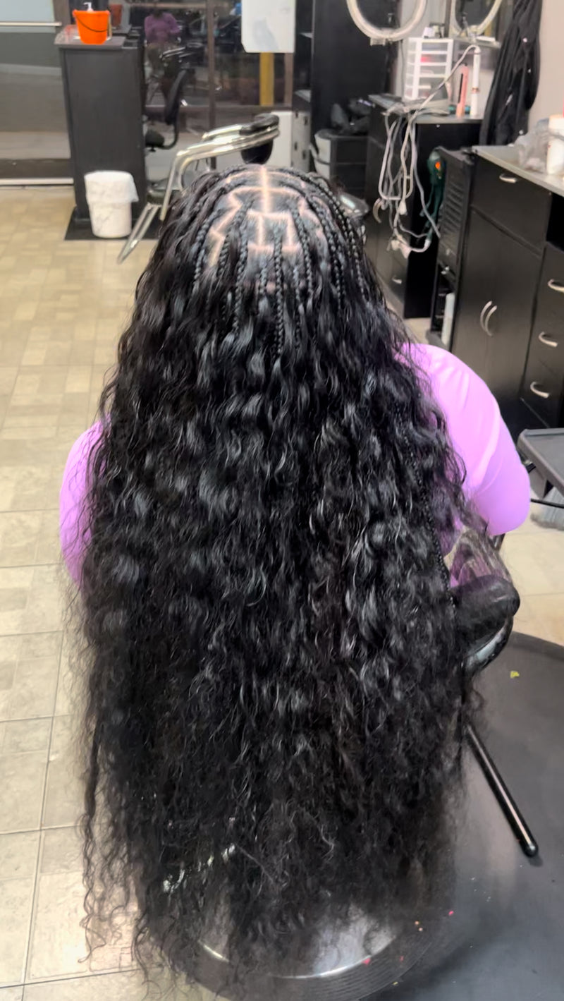 Long flowing raw Indian curly hair bundles installed with cornrow braids for a stylish look