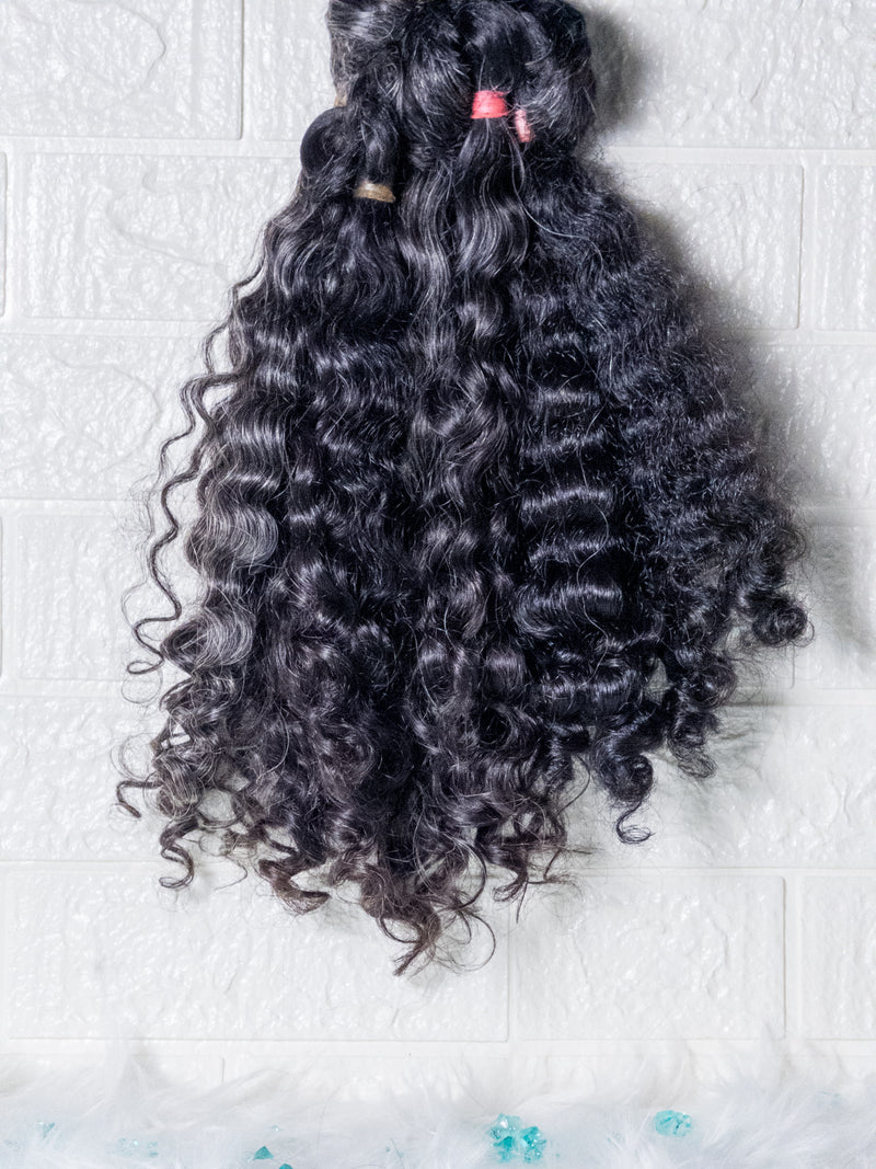 Raw Indian curly hair bundles in natural black with defined curls and soft texture