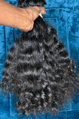 Raw Indian curly hair bundles with natural waves and soft texture for versatile styling options