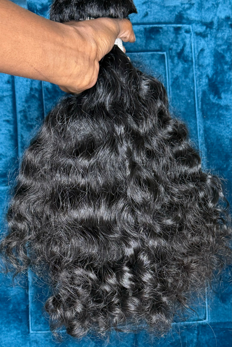 Raw Indian curly hair bundles with natural waves and soft texture for versatile styling options