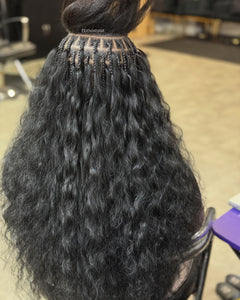 Raw Indian wavy hair styled with intricate braids for a natural look and easy maintenance